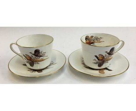 A pair of large bone china Hammersley &amp; Co cups and saucers, depicting pheasants in flight 