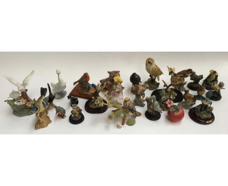 A large quantity of bird figurines, to include a Goebel porcelain figurine of a long tailed titmouse, marked to base, 13cmH; 