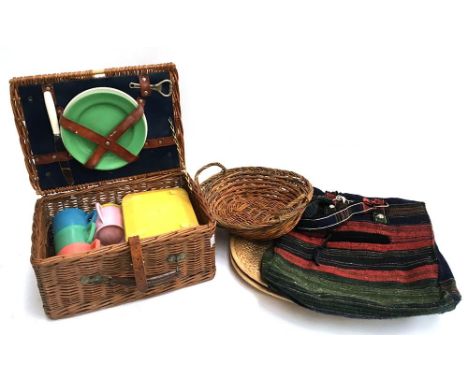 A vintage wicker picnic hamper with fittings and melamine and plastic cups etc; together with a small wicker bread basket and