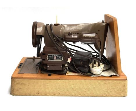 A vintage electric Singer sewing machine, no. K10471592, in carry case 
