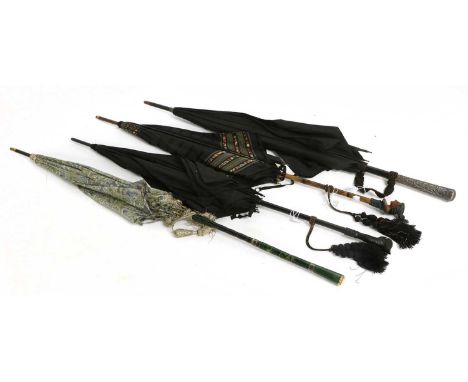 Early 20th Century Novelty Parasols comprising an ebonised walking stick with a carved parrot head handle, inset with glass e