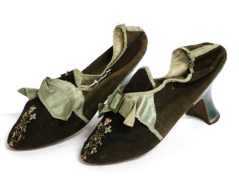 A Pair of Late 18th Century Lady's Shoes in black wool, mounted with pale blue silk trims and bows, floral embroidery to the 