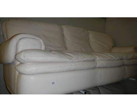 A 3 seat cream leather sofa.