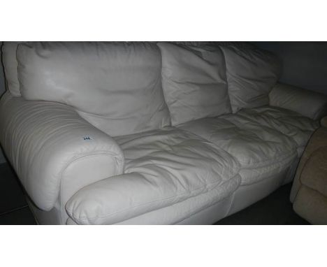 A 3 seat cream leather sofa.