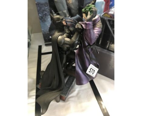 An Arkham Origins video game collectors edition figurine of Batman and Joker.