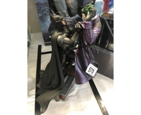 An Arkham Origins video game collectors edition figurine of Batman and Joker.