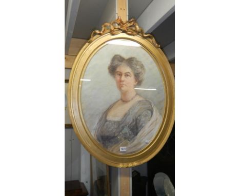 An oval framed portrait of a lady.