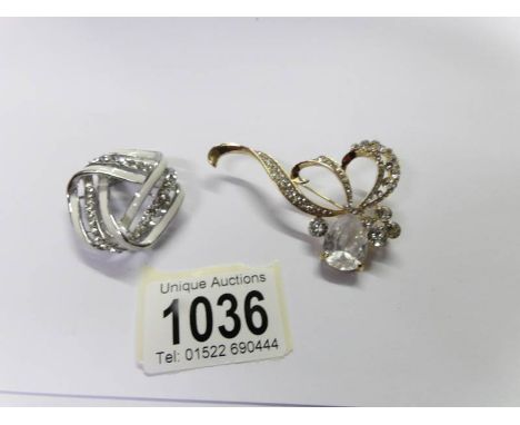 A jewelled brooch and a jewelled scarf clip.