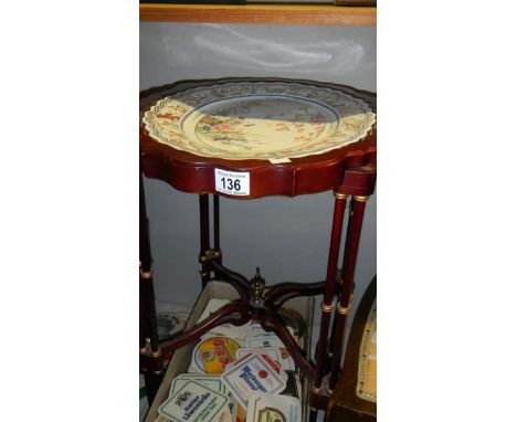 A mahogany table with ceramic top.