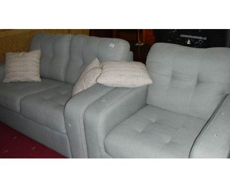 A 2 seat sofa and a chair.