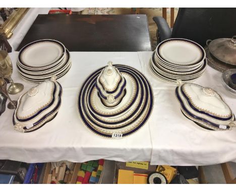A Royal Worcester W614 part dinner set in blue, cream and gold including meat platters, tureens etc.