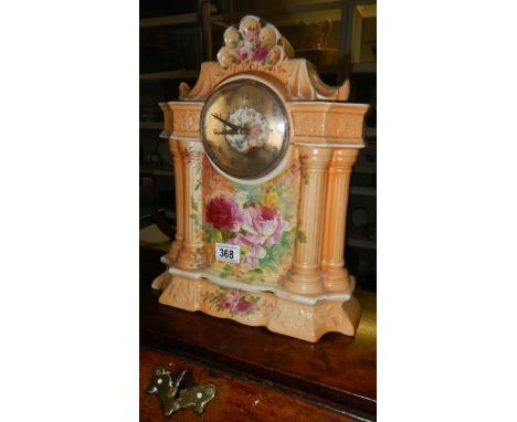 A floral decorated ceramic mantel clock.
