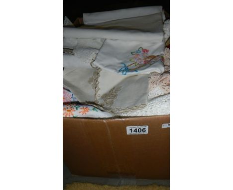 A box of vintage household linen and textiles.