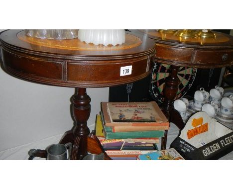 A pair of tripod drum tables.
