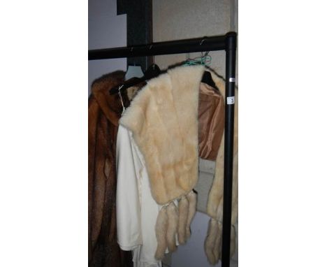 A fur coat, fur stole and one other item.
