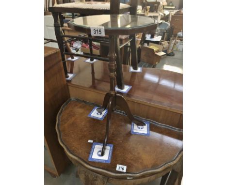 A tripod wine table with glass top.