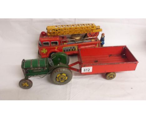 A Mettoy tinplate clockwork tractor and trailer, and a tinplate friction fire engine.