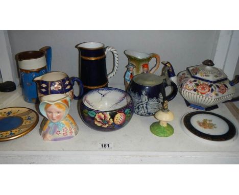 A shelf of assorted jugs, bowls, teapot, teapot stands etc.,