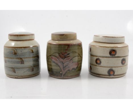 David Leach, three Lowerdown Pottery jars and covers, all cylindrical form, one with iron painted foxglove motif against a mo