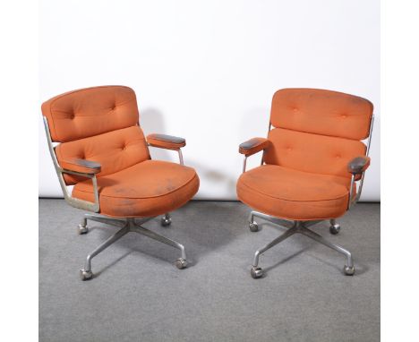Charles and Ray Eames for Herman Miller, two armchairs, model ES104, 1970s, aluminium frames, orange cotton pads, four-wheel 