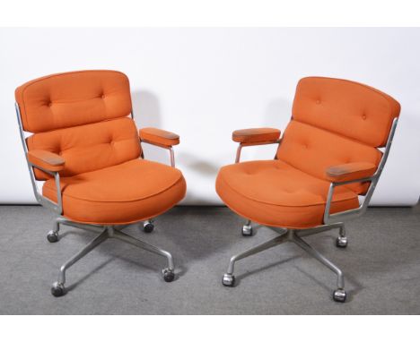 Charles and Ray Eames for Herman Miller, two armchairs, model ES104, 1970s, aluminium frames, orange cotton pads, four-wheel 