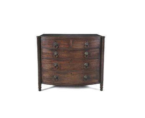 AN IRISH GEORGE IV MAHOGANY BOWFRONT CHEST, probably Cork, the shaped top with outset ropetwist pilasters, enclosing two shor
