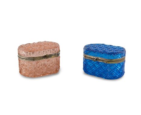 A BOHEMIAN MOULDED BLUE GLASS TRINKET BOX, with metal mounts; together with a pink glass example. Each 13.5cm wide, 9cm high 