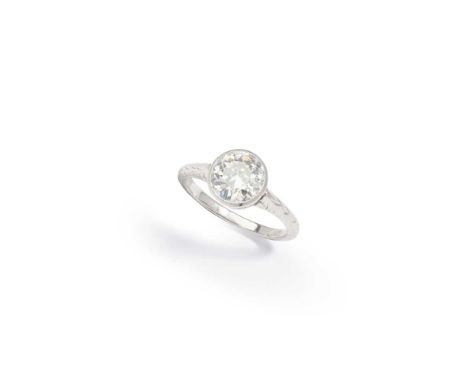 A diamond single-stone ring Millegrain-set with an old brilliant-cut diamond, between engraved shoulders, Austrian assay mark