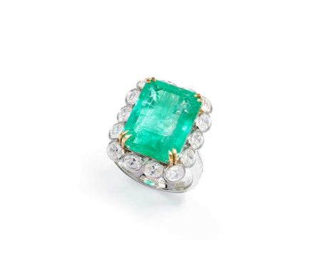 An emerald and diamond cluster ring The cut-cornered step-cut emerald, weighing 14.75 carats, to an oval-cut diamond surround