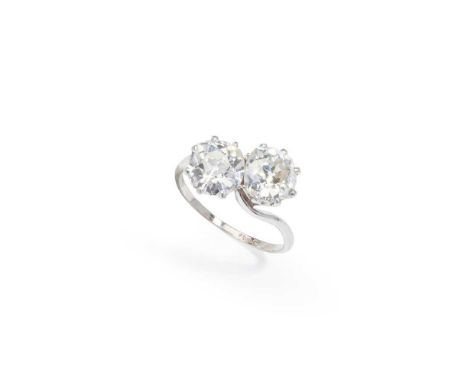 A diamond two-stone ring Of crossover design, set with two old cushion-shaped diamondsDimensions:Ring size: N/O