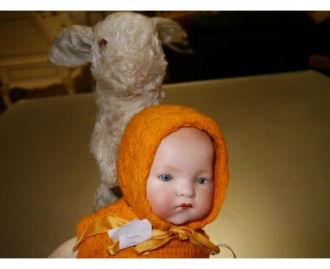 An Armand Marseille bisque socket head doll with open and shut blue eyes, on a ball-jointed composition body, the head impres