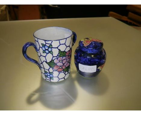 A pottery twin-handled cup, c. 1920, painted with floral sprays, signed J. W. Wilson to the base; together with a small potte