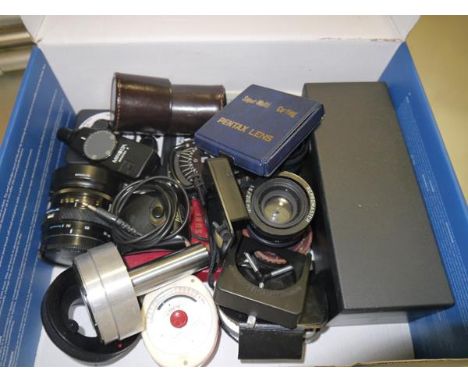 A box containing a collection of camera equipment to include light meters, filters and lenses