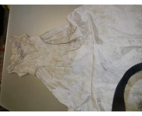 A vintage embroidered ivory satin wedding dress, c. 1940/50, embellished with bugle and pearl beads.