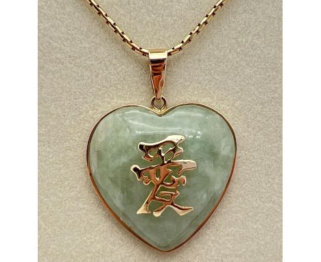 A 9ct gold heart shaped pendant set with pale green jade, with 9ct gold Chinese characters to front. On an 18" box style chai