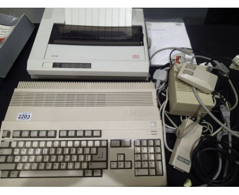 Commodore Amiga A500 personal computer, with power supply and mouse, with an AEG Olympia NP-60 printer. Together with twenty 