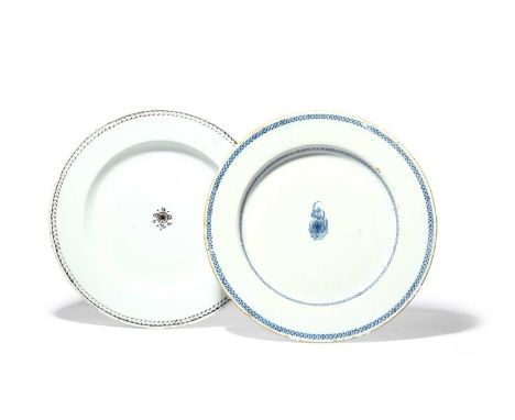 Two large delftware chargers, c.1780, simply decorated in blue or manganese with a small central flower sprig, the rims with 