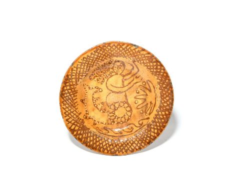 A large Toft-style slipware dish or charger, probably 19th century, decorated in the manner of Thomas Toft in treacle and cre