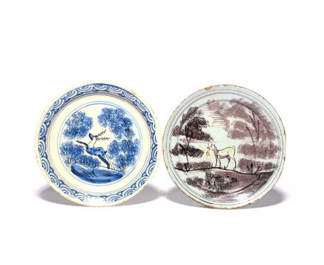 Two delftware plates, c.1720-40, probably London, one painted in manganese and yellow with a dog carrying a stick between tal