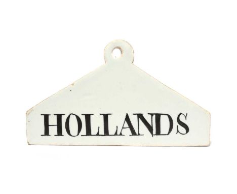 A delftware bin label, c.1770-80, of coathanger form, painted in black with 'HOLLANDS', 13.7cm across.