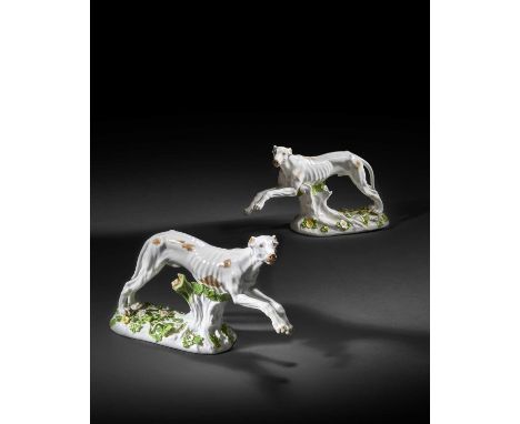 A large pair of Meissen figures of greyhounds, c.1745-50, modelled by Johann Joachim Kändler, each in pursuit with forepaws l