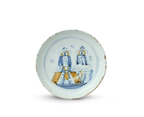 A London delftware Royal portrait plate or shallow dish, c.1690, painted in blue and ochre with the double portrait of King W