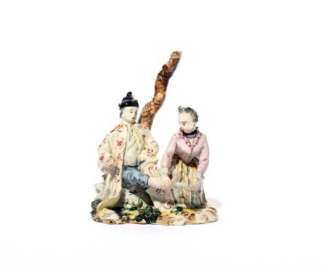 A Savona faïence figure group, c.1770-80, modelled by Giacomo Boselli with a man seated beneath a bare tree trunk while his k
