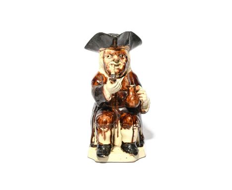 A creamware Step or 'Twyford' Toby jug, c.1780-90, seated with a jug in his left hand, a long clay pipe between his teeth, su