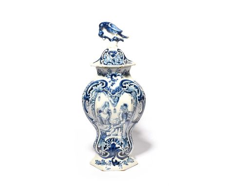 A Delft vase and cover, 18th century, the flattened hexagonal form painted on one side with an elaborate cartouche featuring 