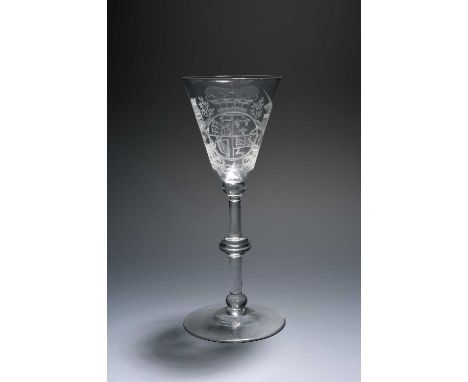 A Dutch-engraved Newcastle light baluster glass, c.1740-50, the round funnel bowl well engraved with the Royal coat of arms f