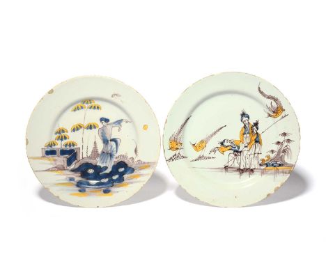 Two delftware plates, c.1750-70, one painted in blue, manganese and yellow with three Chinese figures beside long-tailed phea
