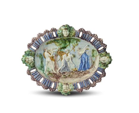 A large maiolica dish attributed to Bernard Palissy, c.1600, moulded in high relief with a Bacchanalian scene, showing the dr