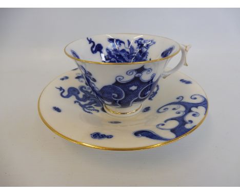A Royal Worcester cup and saucer, circa 1907 depicting Oriental style blue and white dragons. 