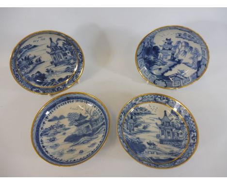 Four Chinese blue and white saucers with gilded rims, probably 19th Century or earlier, each 5" diameter. 